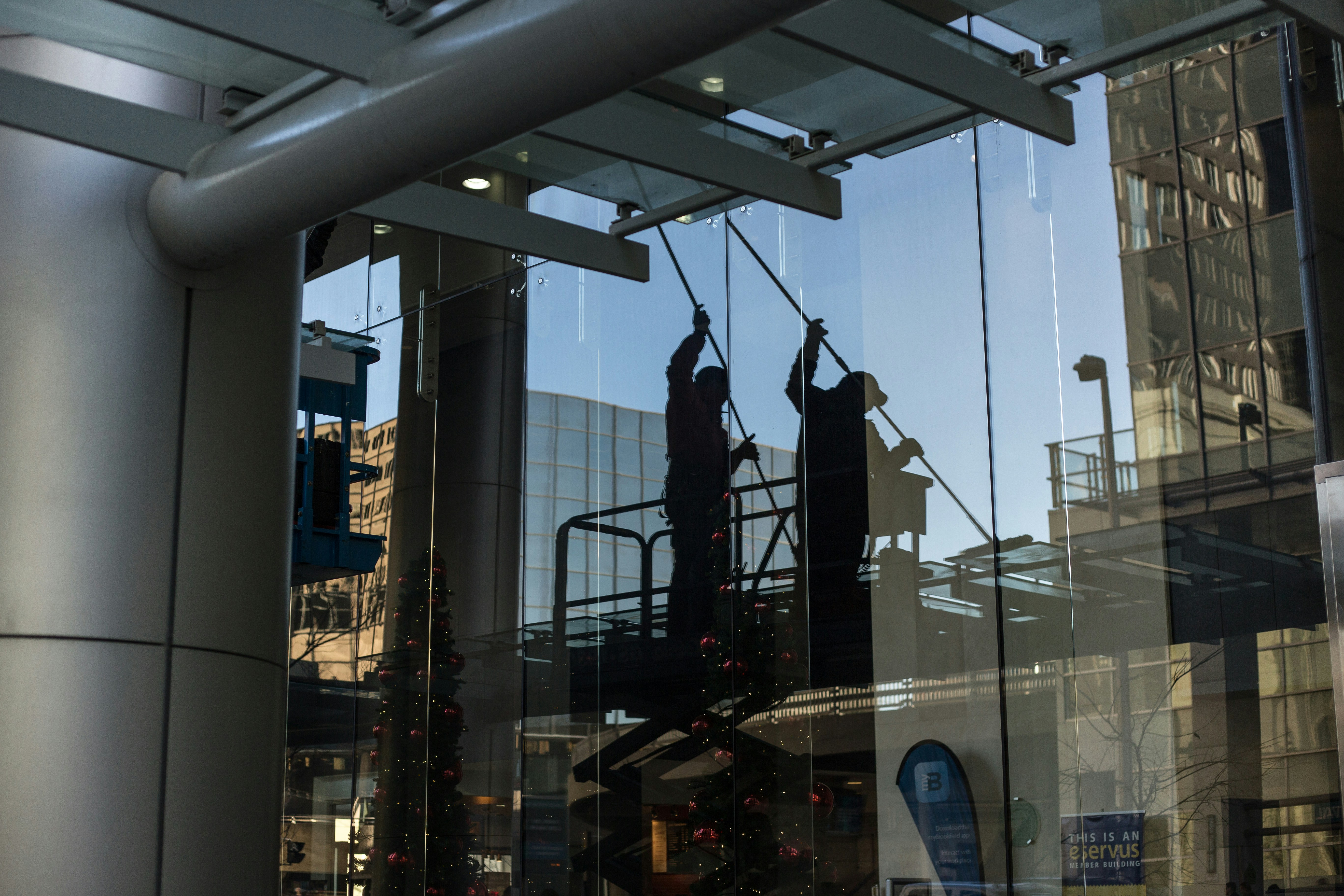 A glass crew installing a commercial glass curtain wall